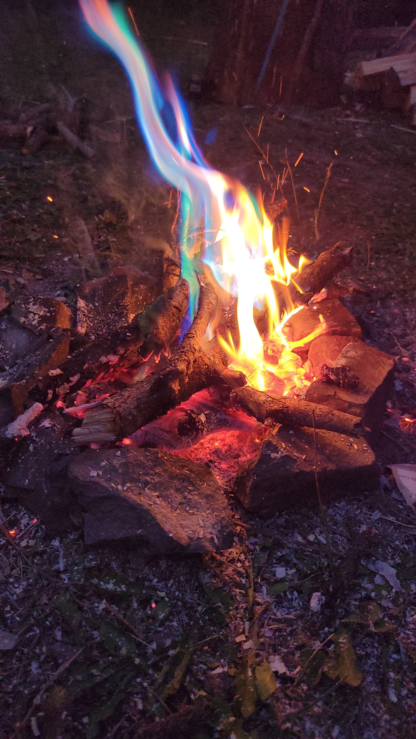 Aurora Inferno color-changing campfire flames in blue, green, and purple.